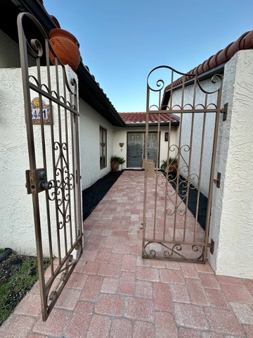 Wrought iron gate leading to the front entry courtyard