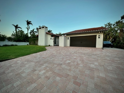 Front exterior with tile roof and paver driveway