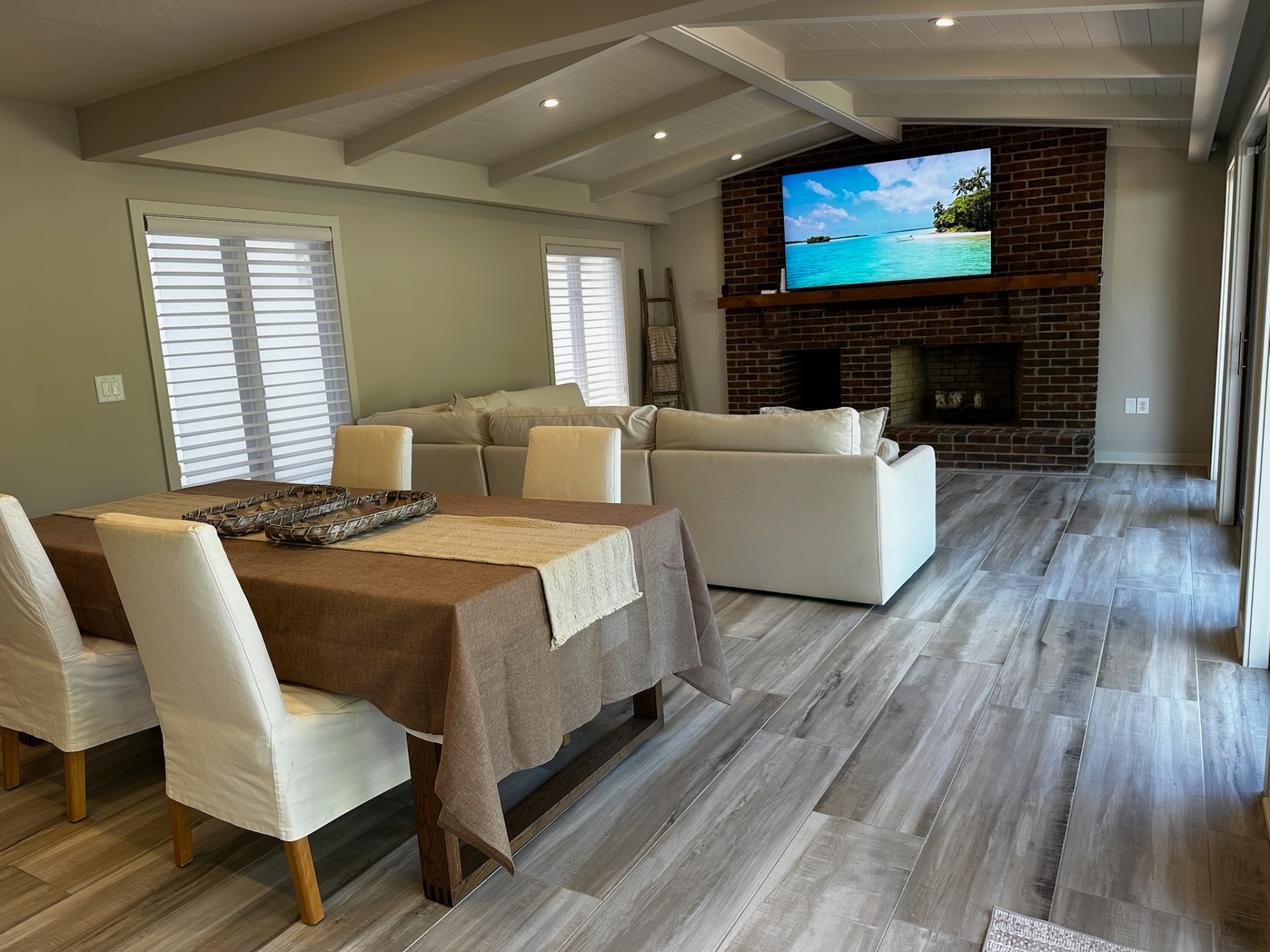 Dining area beside the brick fireplace